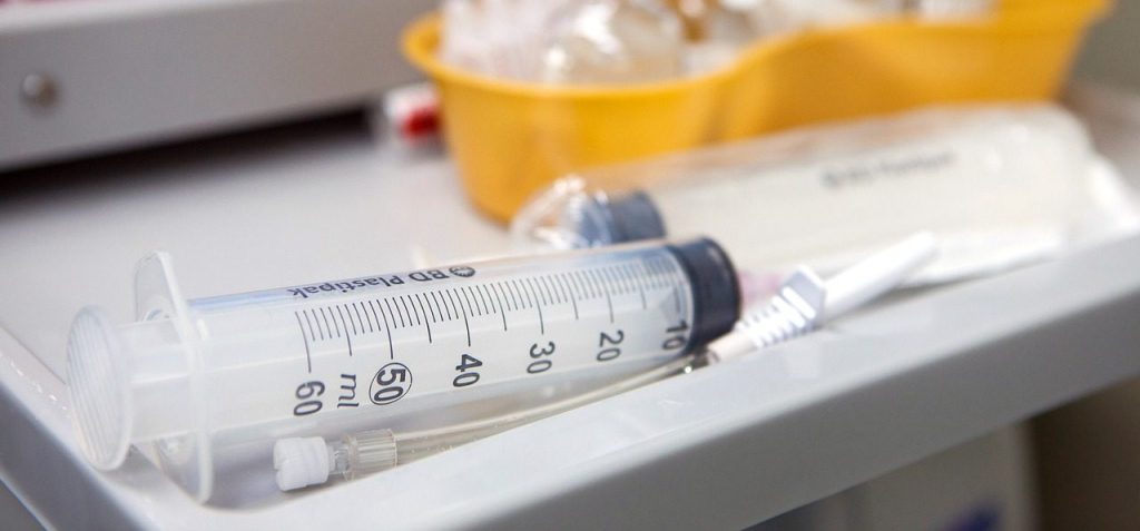 injection syringe on a medical table